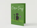Front of Floral Feline apology card featuring a cute cat holding a flower on a green background
