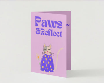 Front of Paws & Reflect apology card showing a serene cat on a purple background

